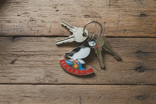 Keychain with puffin design and 'Iceland' text on a white background
