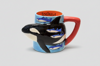 Iceland orca whale mug with 3D killer whale design, blue body, red handle, orange interior labeled “Iceland,” fun Iceland souvenir coffee cup.