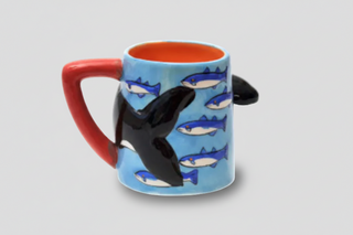 Iceland orca whale mug with 3D killer whale design, blue body, red handle, orange interior labeled “Iceland,” fun Iceland souvenir coffee cup.
