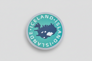 Round sticker with map of Iceland and text 'ICELAND' in multiple languages on a teal background