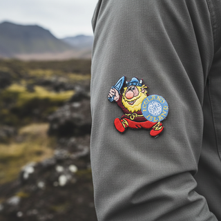 Embroidered patch of a cartoon Viking holding a sword and shield with 'Iceland' on a white background