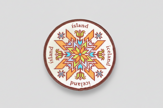 Round patch with a colorful snowflake design and 'Iceland' text on a white background