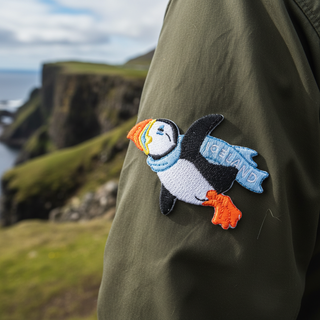 Embroidered patch of a puffin with colorful beak on a white background