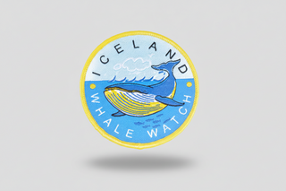 Round patch with a whale design and 'Iceland Whale Watch' text on a blue background