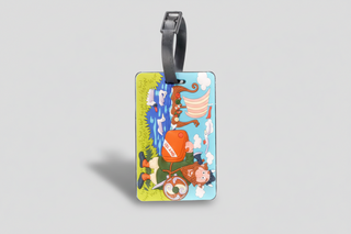 Iceland Viking luggage tag with cartoon Viking holding an orange suitcase, longship and seabirds design, colorful Iceland travel souvenir.