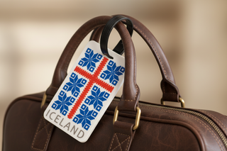 Iceland flag luggage tag with blue and red Nordic cross design and black strap, minimalist Iceland travel souvenir.
