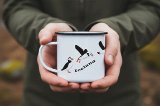 White mug with puffin illustrations and 'Iceland' text on a white background
