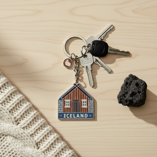 Icelandic turf house enamel keychain with traditional wooden and stone house design and Iceland map charm