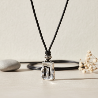 Iceland rune necklace with silver-tone Nordic rune pendant on black cord, Viking-inspired Iceland souvenir jewelry.