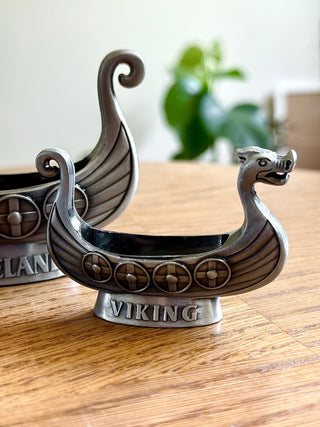 Viking ship decorative item on a wooden surface with a blurred background