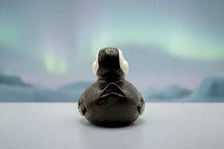 Black rubber duck with white beak on a white background