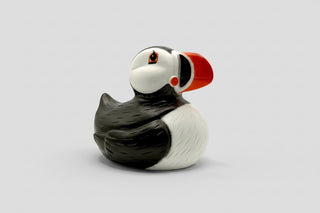 Rubber duck shaped like a puffin on a white background