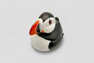 Rubber duck shaped like a puffin on a white background