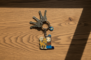 Keychain with a character and a lion on a white background
