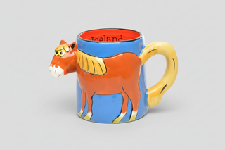 Icelandic horse mug with colorful 3D horse design, blue body, yellow handle, and orange interior labeled “Iceland,” fun Iceland souvenir coffee cup.
