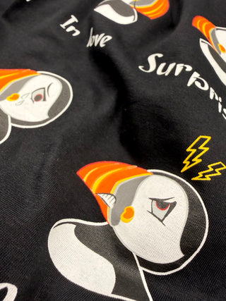 Black fabric with cartoon penguin design and text