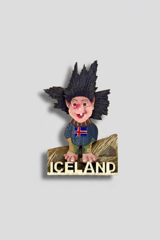 Fridge magnet with a cartoon character wearing an Icelandic sweater on a white background