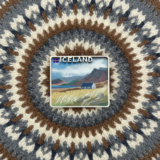 Fridge magnet with a scenic illustration of Iceland featuring a house and mountains.