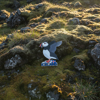 Wooden magnet of a puffin with Iceland text and flag on a white background
