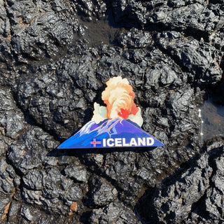 Fridge magnet shaped like Iceland with mountains and text on a white background