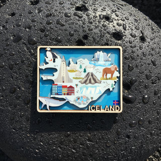 Fridge magnet with a map of Iceland featuring landmarks and animals on a white background.