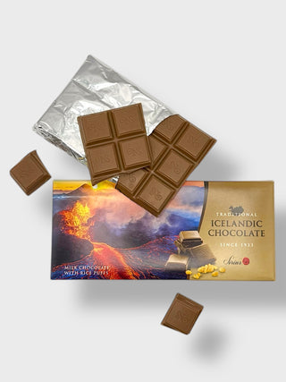 Traditional Icelandic milk chocolate with rice puffs, partially unwrapped, showing chocolate squares and volcanic landscape packaging

