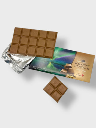 Traditional Icelandic milk chocolate with raisins and hazelnuts, partially unwrapped, showing chocolate squares and Northern Lights packaging