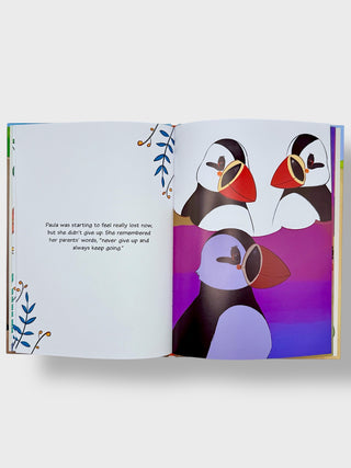 Open book with colorful illustration of puffins on a white background