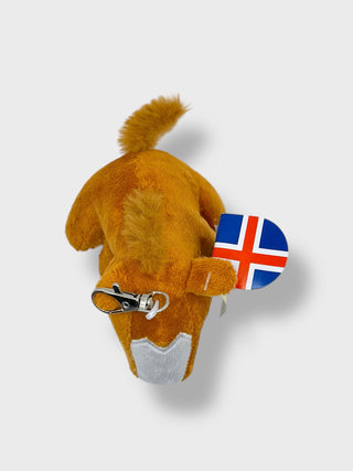 Plush horse toy with a icelandic flag tag on a white background
