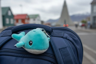 Plush whale-shaped keychain on a white background
