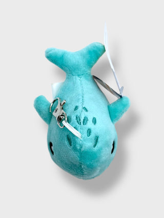 Plush whale toy with a keychain on a light gray background