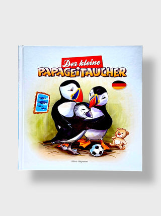 Book cover with puffins, a teddy bear, and soccer ball on a light blue background
