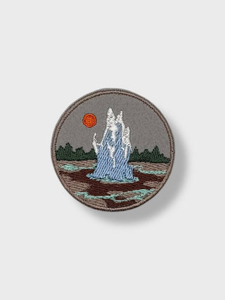 Round 5 cm (2 in) iron-on embroidered patch showing an Icelandic geyser erupting against a natural landscape.