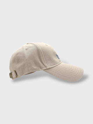 Beige baseball cap on a light gray background