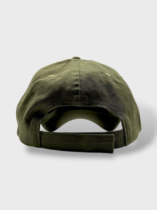 Green baseball cap on a light gray background