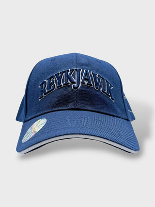 Blue baseball cap with embroidered “Reykjavík” text on the front.