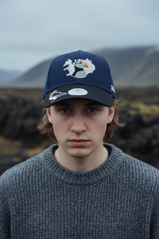 Two-tone cap with puffin design on a light gray background