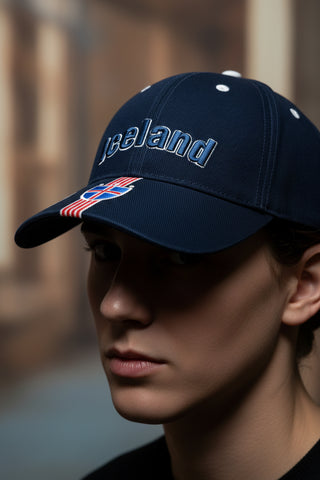 Navy blue cap with 'Iceland' text and flag design on a light gray background
