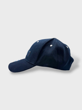 Navy blue baseball cap on a light gray background