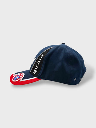 Navy blue cap with 'Reykjavik' text on a light gray background
