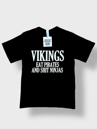 Black t-shirt with white text 'VIKINGS EAT PIRATES AND SHIT NINJAS' on a white background