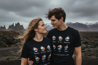 Two people wearing matching black t-shirts with graphic designs in a volcanic landscape.