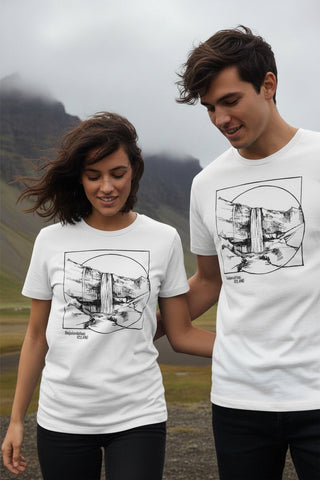 Two people wearing matching white t-shirts with a graphic design in a mountainous landscape.