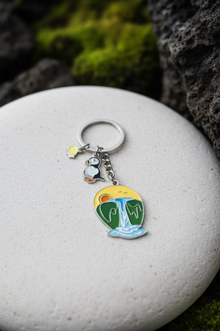 Colorful Iceland puffin keychain with enamel waterfall landscape charm and sunset background souvenir from Iceland