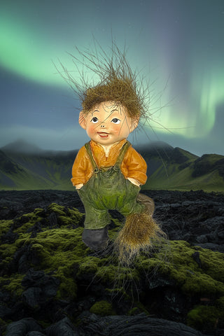 Cute Icelandic baby elf fridge magnet with fluffy wild hair, green overalls, and Nordic folklore-inspired design