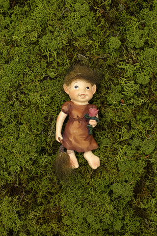 Handpainted Icelandic baby elf girl fridge magnet with fluffy wild hair, little flower, and playful Nordic folklore-inspired design