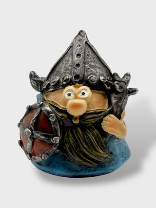 Funny Icelandic Viking warrior statue with shield, beard, and oversized horned helmet

