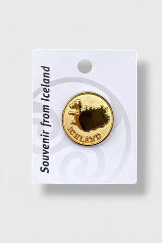 Gold enamel lapel pin featuring the map outline of Iceland on a white souvenir display card