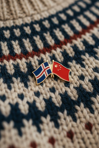 A souvenir lapel pin featuring the flags of Iceland and China
