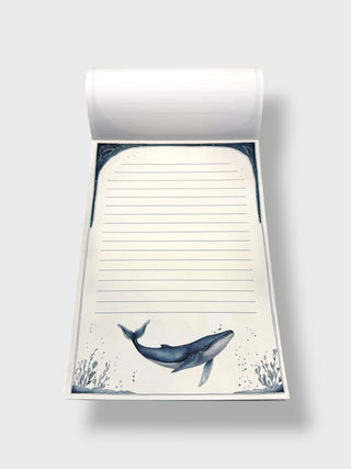 Notepad with whale design on a white background